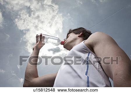 Male runner drinking water View Large Photo Image Stock Photo - Male runner drinking water. Fotosearch