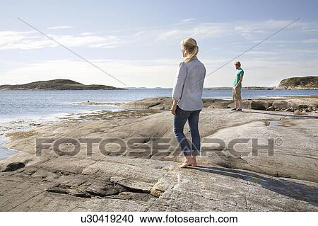 Man and woman looking out to sea View Large Photo Image Stock Image - Man and woman looking out to sea. Fotosearch