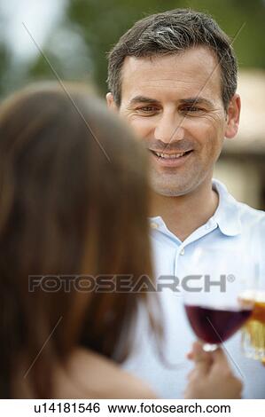 Man and woman toasting each other View Large Photo Image Stock Photograph - Man and woman toasting each other. Fotosearch