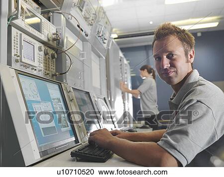 Man and woman work at control desk View Large Photo Image Stock Image - Man and woman work at control desk. Fotosearch