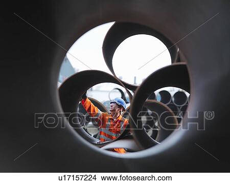 Man checking pipes View Large Photo Image Picture - Man checking pipes. Fotosearch