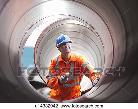 Man checking pipes View Large Photo Image Stock Image - Man checking pipes. Fotosearch