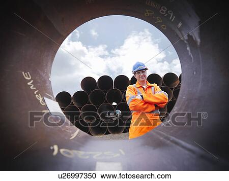 Man checking pipes View Large Photo Image Stock Image - Man checking pipes. Fotosearch