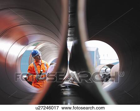 Stock Photo - Man checking pipes. Fotosearch