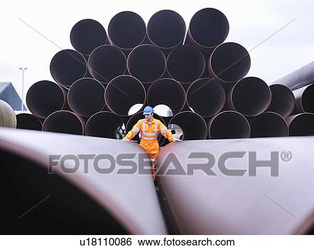 Stock Photograph - Man checking pipes. Fotosearch