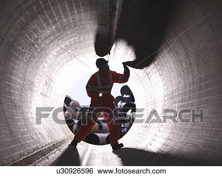 Stock Photograph - Man checking pipes. Fotosearch