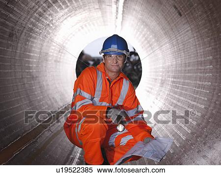 Stock Photography - Man checking pipes. Fotosearch