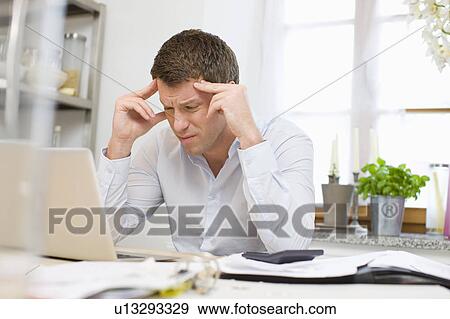 Stock Photo - Man concentrating on a problem. Fotosearch