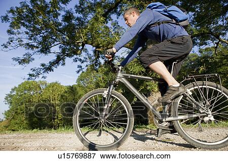 Stock Photo - Man cycling with mountain bike. Fotosearch