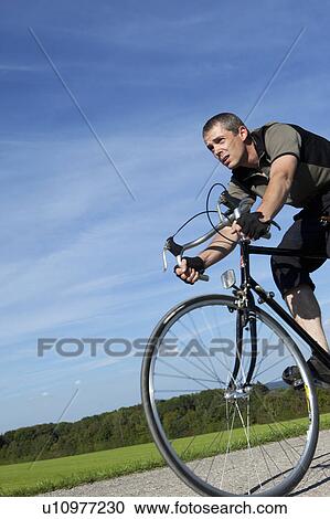 Man cycling with road bike View Large Photo Image Stock Image - Man cycling with road bike. Fotosearch