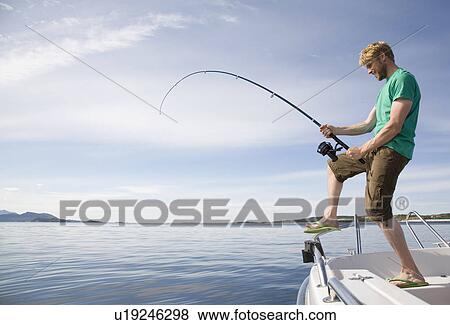 Man deep-sea fishing from boat View Large Photo Image Stock Photo - Man deep-sea fishing from boat. Fotosearch