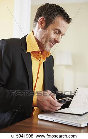 Man dialing number on cellphone View Large Photo Image Stock Photo - Man dialing number on cellphone. Fotosearch