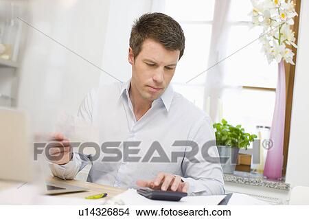 Man doing account stuff View Large Photo Image Picture - Man doing account stuff. Fotosearch