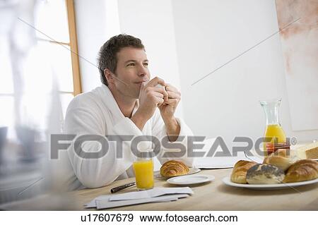 Stock Photo - Man enjoying his breakfast. Fotosearch