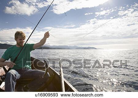 Man fishing on wooden boat View Large Photo Image Stock Image - Man fishing on wooden boat. Fotosearch