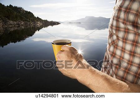 Man having coffee by sea and mountains View Large Photo Image Stock Image - Man having coffee by sea and mountains. Fotosearch