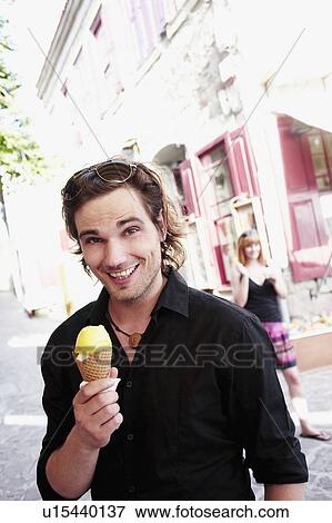 Stock Photo - Man holding ice cream cone. Fotosearch
