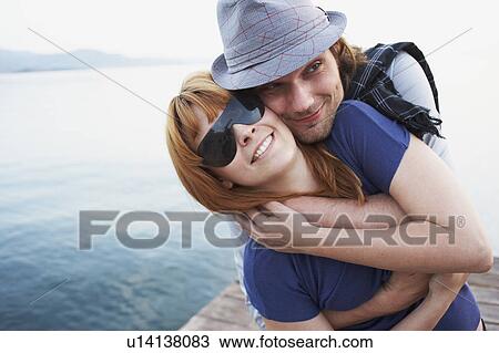 Man hugging girlfriend View Large Photo Image Stock Image - Man hugging girlfriend. Fotosearch