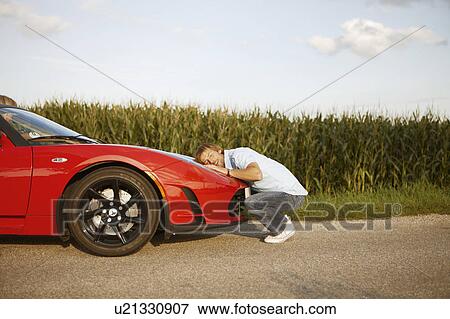 Man hugging his electric sports car View Large Photo Image Stock Photo - Man hugging his electric sports car. Fotosearch