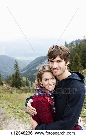 Stock Photograph - Man hugging woman. Fotosearch