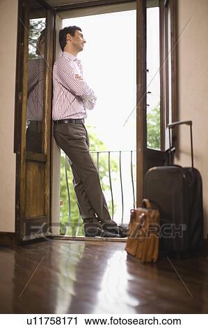 Man in a hotel room View Large Photo Image Stock Image - Man in a hotel room. Fotosearch