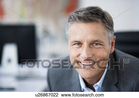 Stock Image - Man in suit smiling to camera. Fotosearch