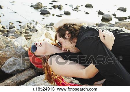 Stock Image - Man kissing woman on neck. Fotosearch