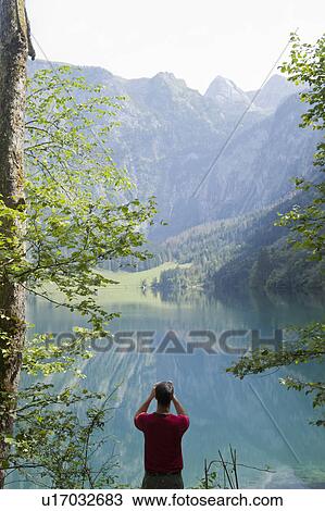 Man making photos of mountains and a sea View Large Photo Image Stock Image - Man making photos of mountains and a sea. Fotosearch