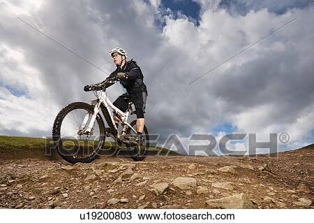 Man mountain biking down hill View Large Photo Image Stock Image - Man mountain biking down hill. Fotosearch