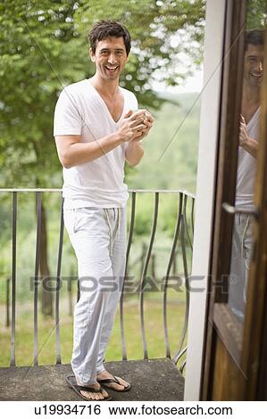 Man on a balcony View Large Photo Image Stock Photograph - Man on a balcony. Fotosearch
