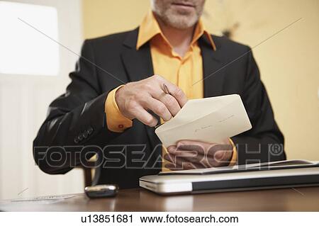 Man opening letter View Large Photo Image Stock Image - Man opening letter. Fotosearch