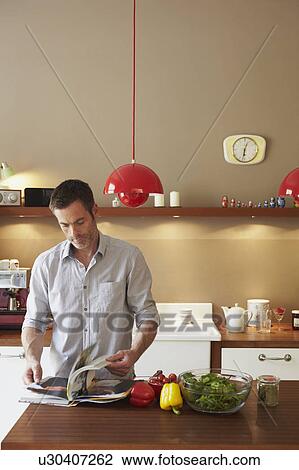 Man reading cookbook View Large Photo Image Stock Image - Man reading cookbook. Fotosearch