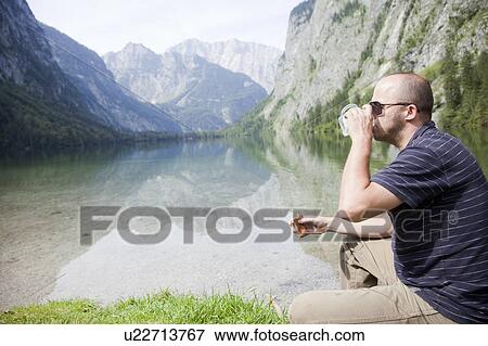 Stock Photo - Man refreshing at a sea. Fotosearch