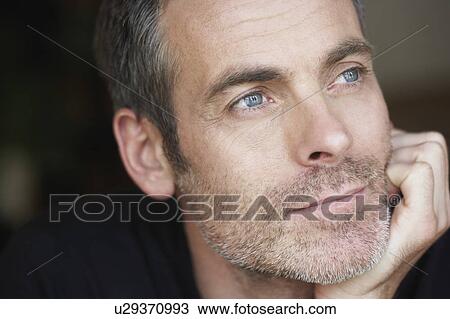 Man resting his head upon hand View Large Photo Image Stock Image - Man resting his head upon hand. Fotosearch