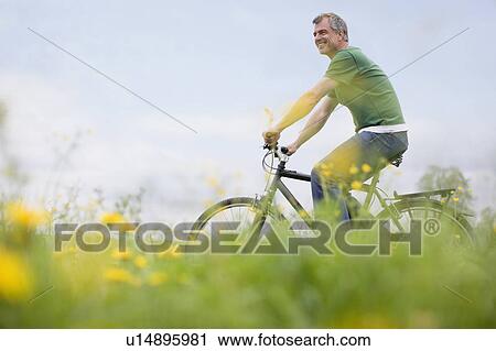 Man riding bike View Large Photo Image Stock Image - Man riding bike. Fotosearch
