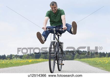 Man riding bike View Large Photo Image Stock Photograph - Man riding bike. Fotosearch