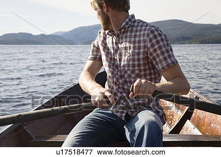 Stock Photo - Man rowing boat. Fotosearch
