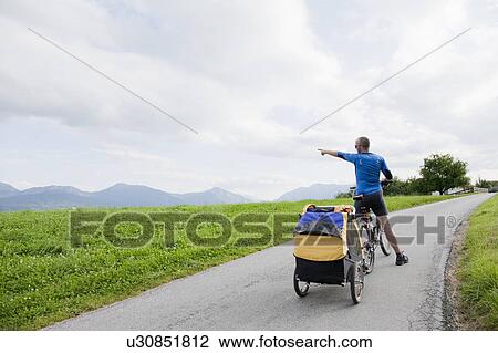 Stock Image - Man showing a child something. Fotosearch