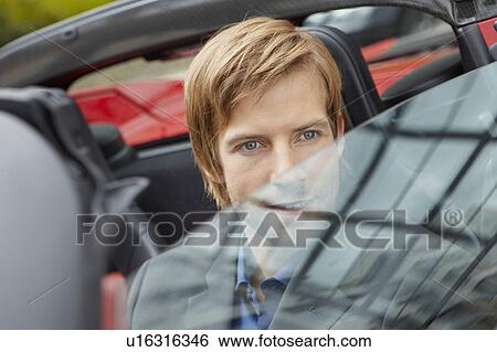 Man sitting in his electric sports car View Large Photo Image Stock Photograph - Man sitting in his electric sports car. Fotosearch