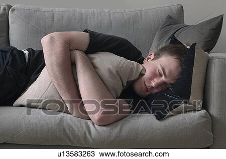 Man sleeping on sofa View Large Photo Image Stock Image - Man sleeping on sofa. Fotosearch
