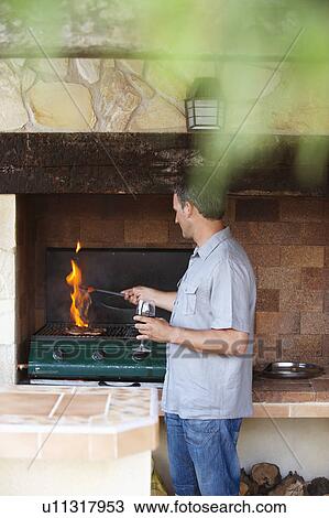 Man standing by barbeque View Large Photo Image Stock Image - Man standing by barbeque. Fotosearch