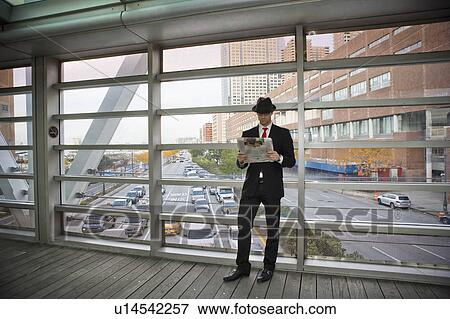 Stock Photo - Man standing on bridge. Fotosearch