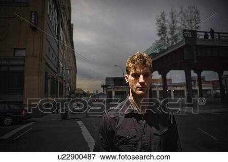 Stock Photo - Man standing on city street. Fotosearch
