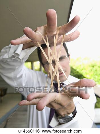 Man stretches elastic bands View Large Photo Image Stock Photograph - Man stretches elastic bands. Fotosearch
