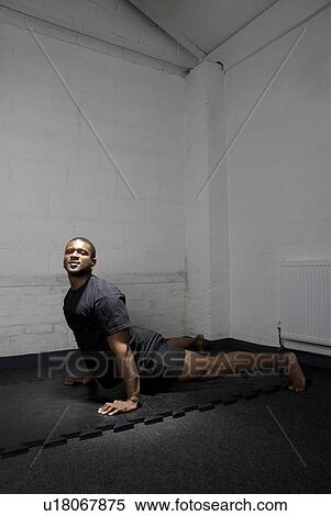 Man stretching on floor View Large Photo Image Stock Photography - Man stretching on floor. Fotosearch
