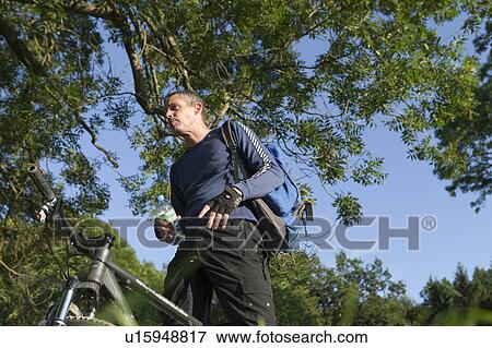 Stock Photo - Man taking a break during cycling. Fotosearch