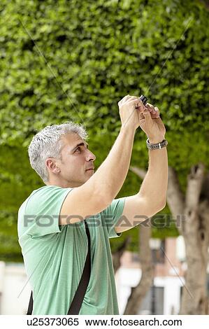Man taking picture with camera View Large Photo Image Stock Photography - Man taking picture with camera. Fotosearch