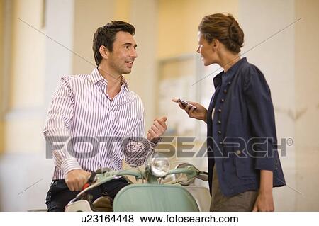 Stock Photo - Man talking to a woman. Fotosearch