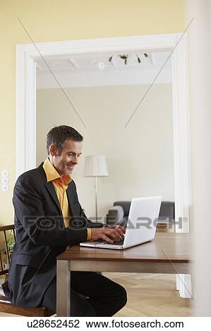 Man typing on laptop View Large Photo Image Stock Image - Man typing on laptop. Fotosearch