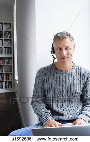Man using headset View Large Photo Image Stock Image - Man using headset. Fotosearch